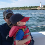 Photo of Ian Koski on a boat with his son