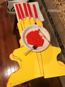 The panels for the side of Daniel Tiger's trolley being painted yellow and red.
